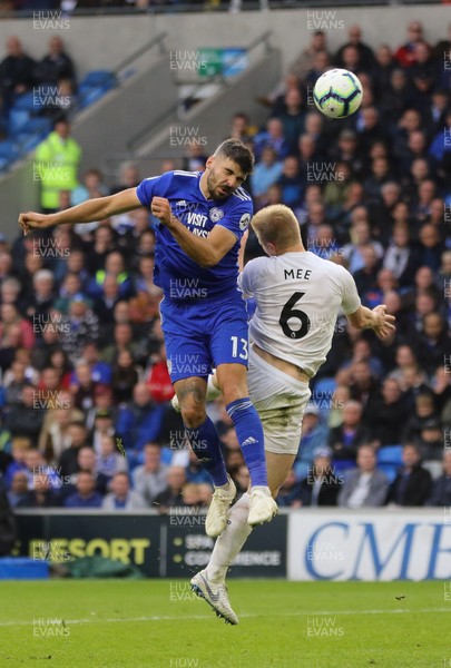 300918 - Cardiff City v Burnley, Premier League - Callum Paterson of Cardiff City heads past Ben Mee of Burnley