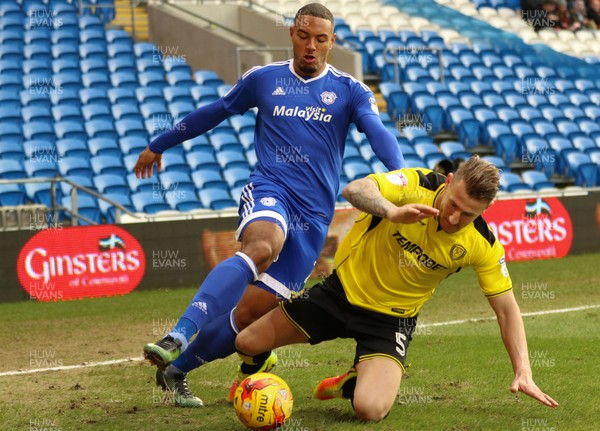 210117 - Cardiff City v Burton Albion, Sky Bet Championship - Kenneth Zohore of Cardiff City and Kyle McFadzean of Burton Albion compete for the ball