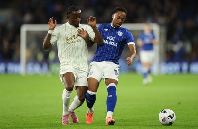 300925 - Cardiff City v Burton Albion, EFL Sky Bet League 1 - Chris Willock of Cardiff City holds off Sebastian Revan of Burton Albion