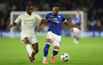 300925 - Cardiff City v Burton Albion, EFL Sky Bet League 1 - Chris Willock of Cardiff City holds off Sebastian Revan of Burton Albion
