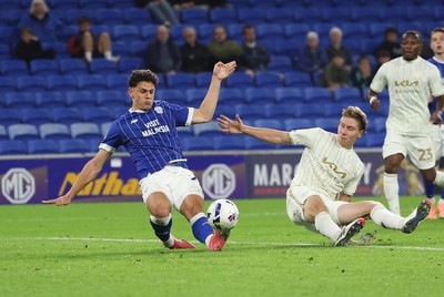 300925 - Cardiff City v Burton Albion, EFL Sky Bet League 1 - Yousef Salech of Cardiff City beats Alex Hartridge of Burton Albion as he shoots at goal