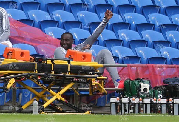 300620 - Cardiff City v Charlton Athletic - SkyBet Championship - Souleymane Bamba of Cardiff City smiles as he sits on the bench
