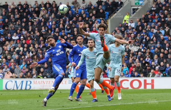 310319 - Cardiff City v Chelsea, Premier League - Marcos Alonso of Chelsea clears as Josh Murphy of Cardiff City closes in