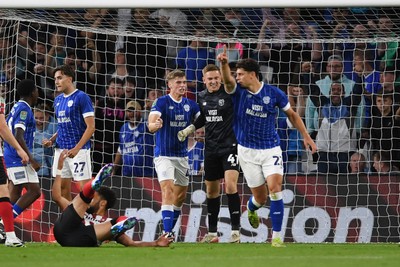 260825 - Cardiff City v Cheltenham Town - Carabao Cup Round Two - Matthew Turner of Cardiff City saves the penalty effort from Lee Angol of Cheltenham Town