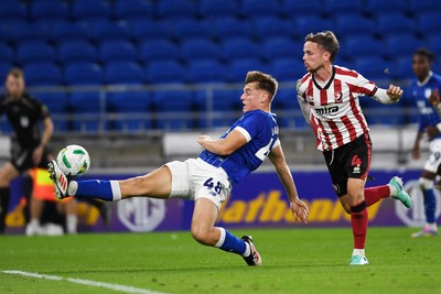 260825 - Cardiff City v Cheltenham Town - Carabao Cup Round Two - Dylan Lawlor of Cardiff City is challenged by Liam Kinsella of Cheltenham Town