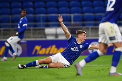 260825 - Cardiff City v Cheltenham Town - Carabao Cup Round Two - Dylan Lawlor of Cardiff City is challenged by Liam Kinsella of Cheltenham Town