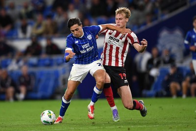 260825 - Cardiff City v Cheltenham Town - Carabao Cup Round Two - Joel Colwill of Cardiff City is challenged by Jokubas Mazionis of Cheltenham Town