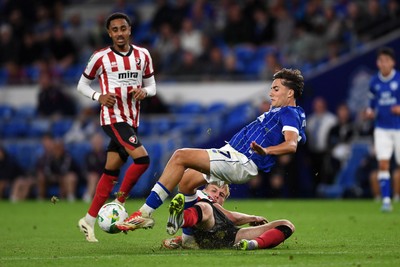 260825 - Cardiff City v Cheltenham Town - Carabao Cup Round Two - Joel Colwill of Cardiff City is challenged by Jokubas Mazionis of Cheltenham Town
