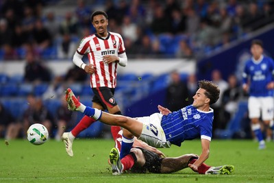 260825 - Cardiff City v Cheltenham Town - Carabao Cup Round Two - Joel Colwill of Cardiff City is challenged by Jokubas Mazionis of Cheltenham Town