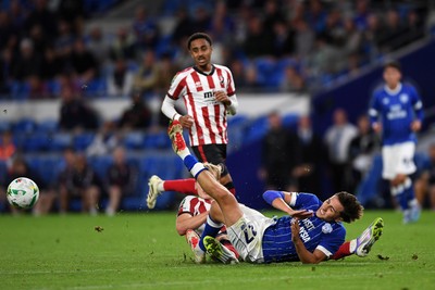 260825 - Cardiff City v Cheltenham Town - Carabao Cup Round Two - Joel Colwill of Cardiff City is challenged by Jokubas Mazionis of Cheltenham Town