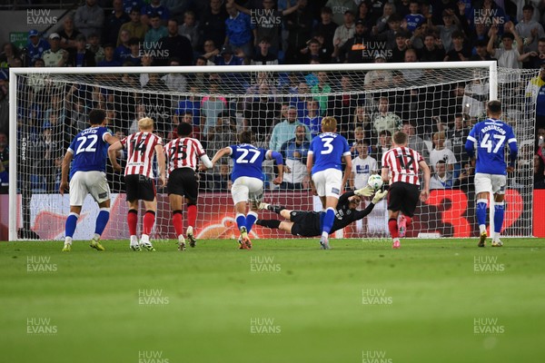 260825 - Cardiff City v Cheltenham Town - Carabao Cup Round Two - Matthew Turner of Cardiff City saves the penalty effort from Lee Angol of Cheltenham Town