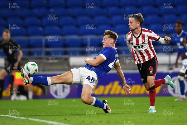 260825 - Cardiff City v Cheltenham Town - Carabao Cup Round Two - Dylan Lawlor of Cardiff City is challenged by Liam Kinsella of Cheltenham Town