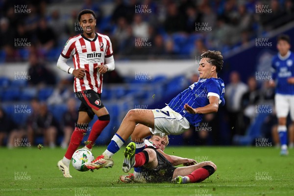 260825 - Cardiff City v Cheltenham Town - Carabao Cup Round Two - Joel Colwill of Cardiff City is challenged by Jokubas Mazionis of Cheltenham Town