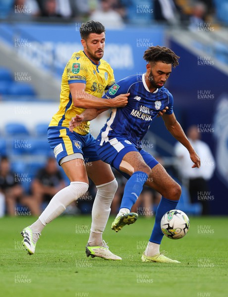 090823 - Cardiff City v Colchester United, EFL Carabao Cup - Kion Etete of Cardiff City is challenged by Connor Hall of Colchester United