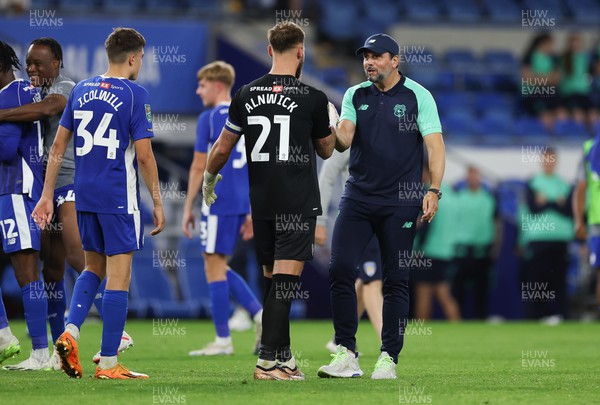 090823 - Cardiff City v Colchester United, EFL Carabao Cup - Cardiff City goalkeeper Jak Alnwick is congratulated by Cardiff City manager Erol Bulut after Cardiff win the match on penalties