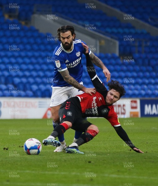 130221 - Cardiff City v Coventry City, Sky Bet Championship - Marlon Pack of Cardiff City and Callum O'Hare of Coventry City compete for the ball
