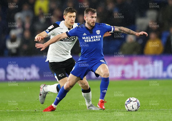 010322 - Cardiff City v Derby County, Sky Bet Championship - Joe Ralls of Cardiff City holds off Krystian Bielik of Derby County