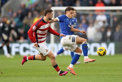 131225 - Cardiff City v Doncaster Rovers - SkyBet League One - Yousef Salech of Cardiff is challenged by Luke Molyneux of Doncaster 