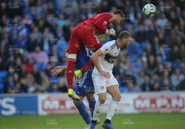 201018 - Cardiff City v Fulham, Premier League - Fulham goalkeeper Marcus Bettinelli is upended as he heads the ball clear