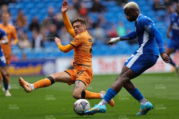 060424 - Cardiff City v Hull City, EFL Sky Bet Championship - Jamilu Collins of Cardiff City is challenged by Regan Slater of Hull City