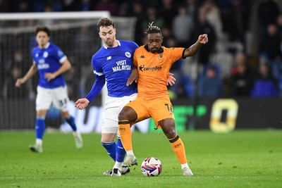 250225 - Cardiff City v Hull City - Sky Bet Championship - Calum Chambers of Cardiff City is challenged by Lincoln BRA of Hull City