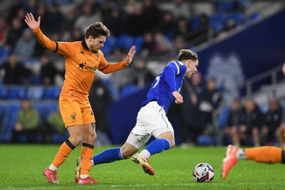 250225 - Cardiff City v Hull City - Sky Bet Championship - Cian Ashford of Cardiff City is tackled by Regan Slater of Hull City just outside the box