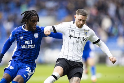 090324 - Cardiff City v Ipswich Town - Sky Bet Championship - Wes Burns of Ipswich Town in action against Josh Wilson-Esbrand of Cardiff City