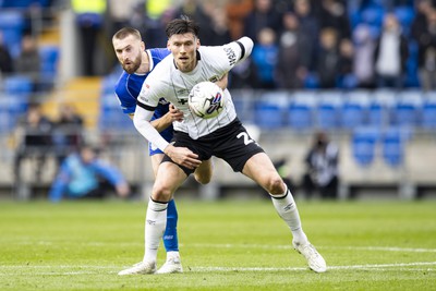 090324 - Cardiff City v Ipswich Town - Sky Bet Championship - Kieffer Moore of Ipswich Town in action against Nathaniel Phillips of Cardiff City