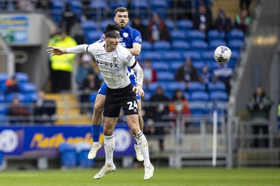 090324 - Cardiff City v Ipswich Town - Sky Bet Championship - Kieffer Moore of Ipswich Town in action against Dimitris Goutas of Cardiff City