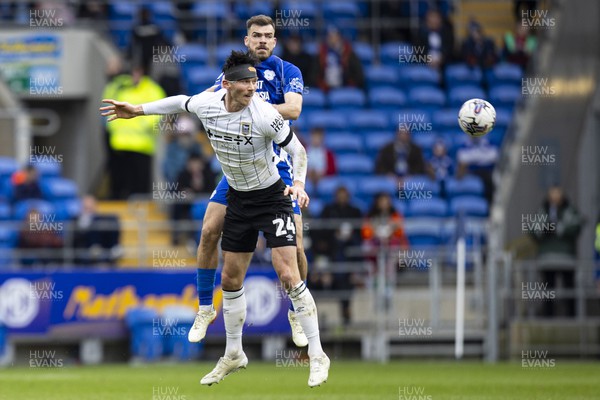 090324 - Cardiff City v Ipswich Town - Sky Bet Championship - Kieffer Moore of Ipswich Town in action against Dimitris Goutas of Cardiff City