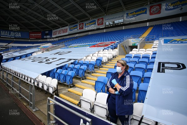 210620 - Cardiff City v Leeds United - SkyBet Championship - The empty stands with a single member of Cardiff staff wearing a face mask and gloves before kick off