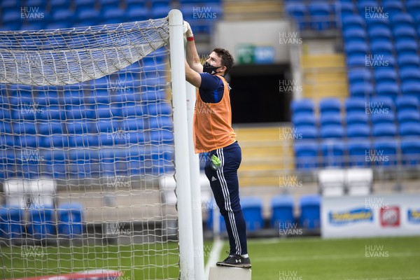 210620 - Cardiff City v Leeds United - SkyBet Championship - A member of Cardiff staff cleans the goal posts before kick off