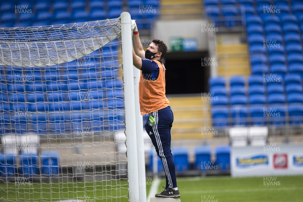 210620 - Cardiff City v Leeds United - SkyBet Championship - A member of Cardiff staff cleans the goal posts before kick off