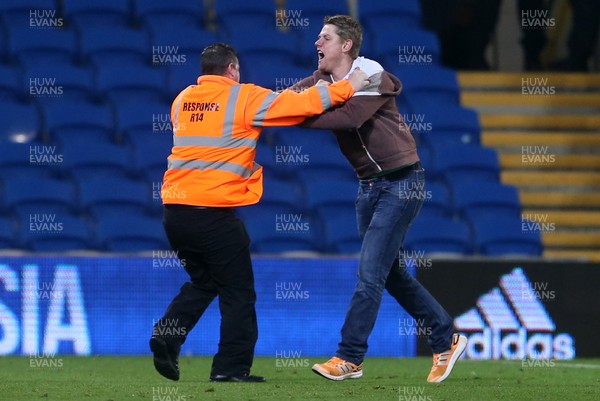 260917 - Cardiff City v Leeds United - SkyBet Championship - A pitch invader is taken down by a steward