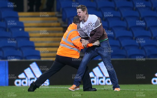 260917 - Cardiff City v Leeds United - SkyBet Championship - A pitch invader is taken down by a steward