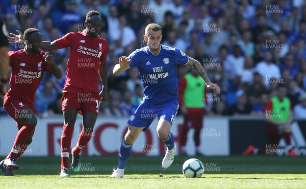 210419 - Cardiff City v Liverpool FC - Premier League - Joe Ralls of Cardiff City is challenged by Sadio Mane of Liverpool