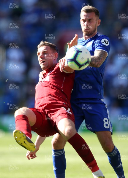 210419 - Cardiff City v Liverpool FC - Premier League - Jordan Henderson of Liverpool is tackled by Joe Ralls of Cardiff City