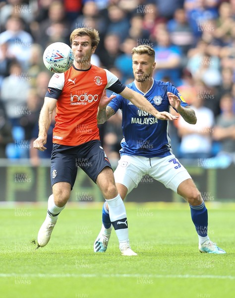 100819 - Cardiff City v Luton Town, Sky Bet Championship - Callum McManaman of Luton Town clears as Joe Bennett of Cardiff City challenges