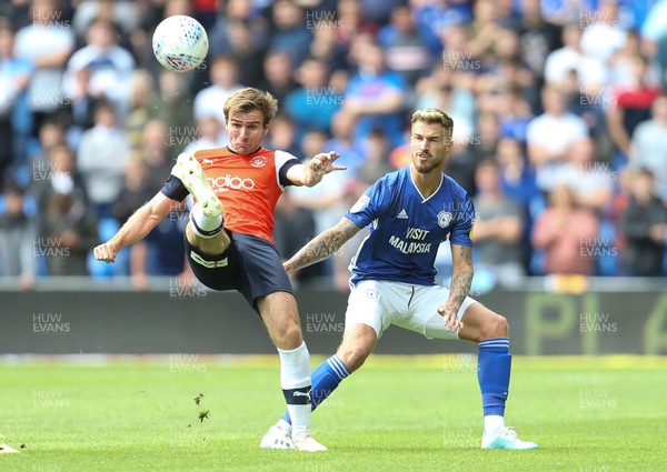 100819 - Cardiff City v Luton Town, Sky Bet Championship - Callum McManaman of Luton Town clears as Joe Bennett of Cardiff City challenges