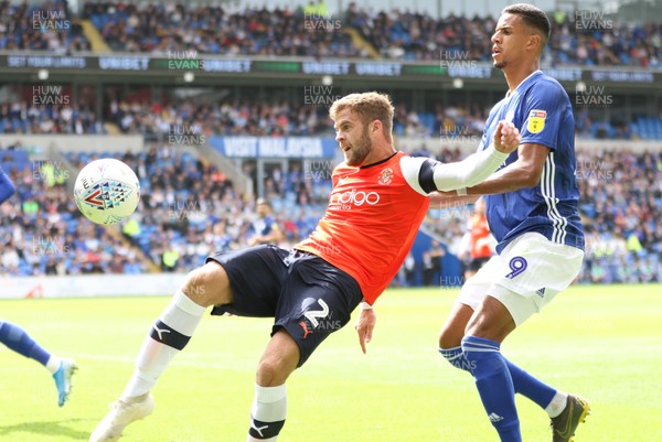 100819 - Cardiff City v Luton Town, Sky Bet Championship - Martin Cranie of Luton Town clears as Robert Glatzel of Cardiff City closes in