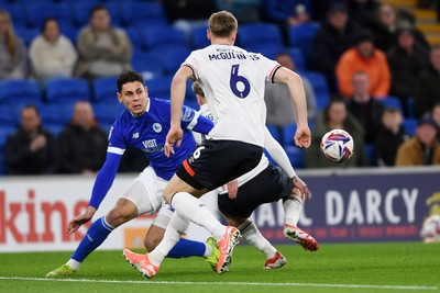 110325 - Cardiff City v Luton Town - Sky Bet Championship - Yousef Salech of Cardiff City is challenged by Mark McGuinness of Luton Town