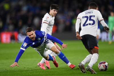 110325 - Cardiff City v Luton Town - Sky Bet Championship - Aaron Ramsey of Cardiff City is challenged by Liam Walsh of Luton Town