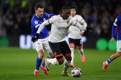 110325 - Cardiff City v Luton Town - Sky Bet Championship - Aaron Ramsey of Cardiff City is challenged by Amari'i Bel of Luton Town