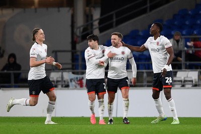 110325 - Cardiff City v Luton Town - Sky Bet Championship - Christ Makosso of Luton Town celebrates scoring the equalising goal with team mates