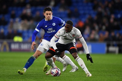 110325 - Cardiff City v Luton Town - Sky Bet Championship - Yousef Salech of Cardiff City is challenged by Amari'i Bel of Luton Town