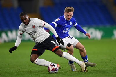 110325 - Cardiff City v Luton Town - Sky Bet Championship - Isaak Davies of Cardiff City is challenged by Amari'i Bel of Luton Town