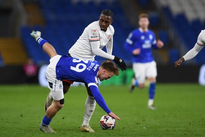 110325 - Cardiff City v Luton Town - Sky Bet Championship - Isaak Davies of Cardiff City is challenged by Amari'i Bel of Luton Town