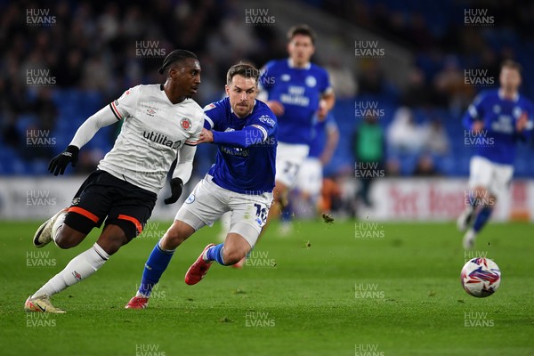 110325 - Cardiff City v Luton Town - Sky Bet Championship - Aaron Ramsey of Cardiff City is challenged by Amari'i Bel of Luton Town