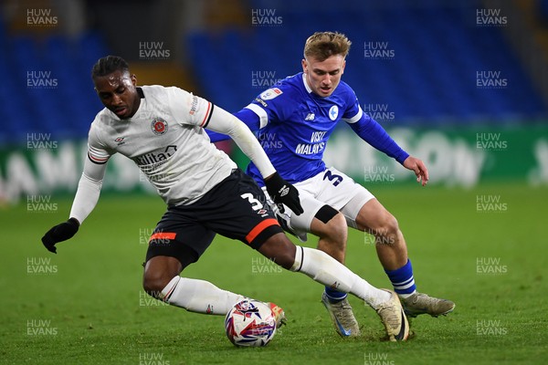 110325 - Cardiff City v Luton Town - Sky Bet Championship - Isaak Davies of Cardiff City is challenged by Amari'i Bel of Luton Town