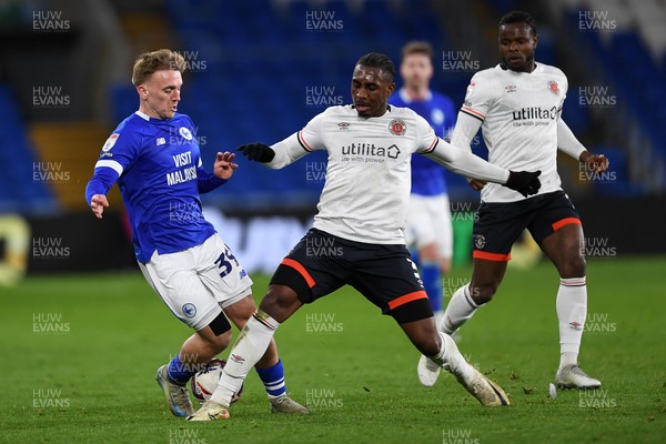 110325 - Cardiff City v Luton Town - Sky Bet Championship - Isaak Davies of Cardiff City is challenged by Amari'i Bel of Luton Town